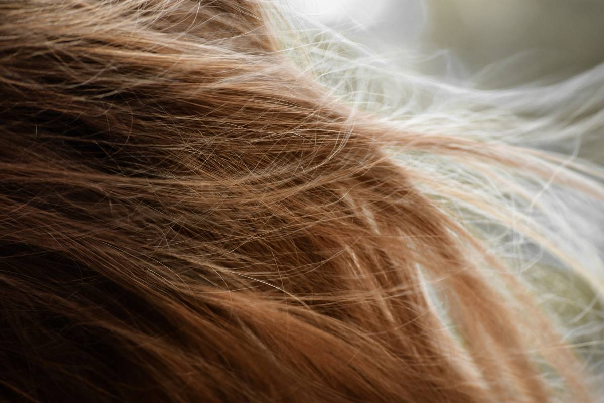 Woman applying delicate scent spray to pulse points for long-lasting fragrance